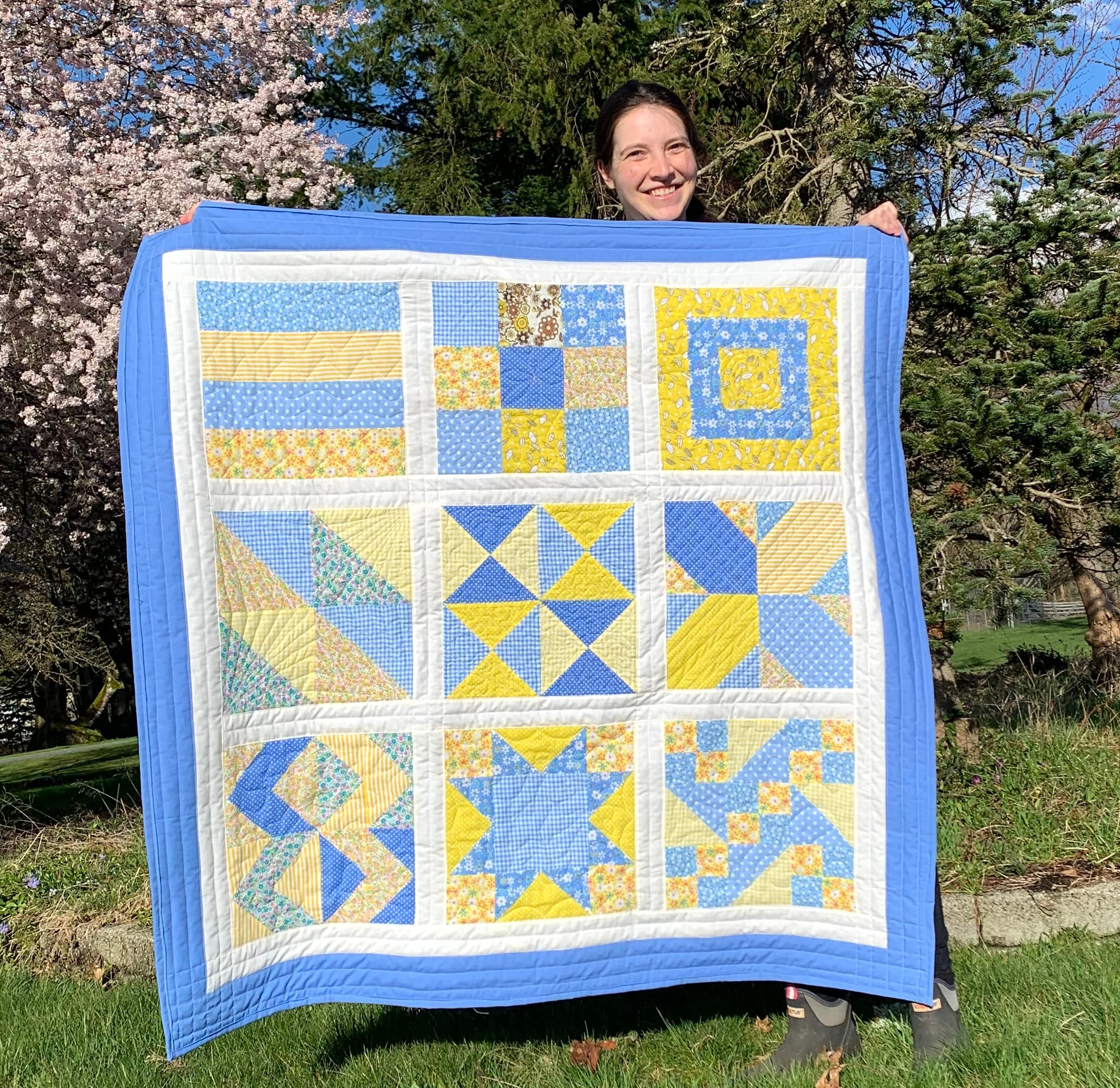 Sydney holding her first quilt